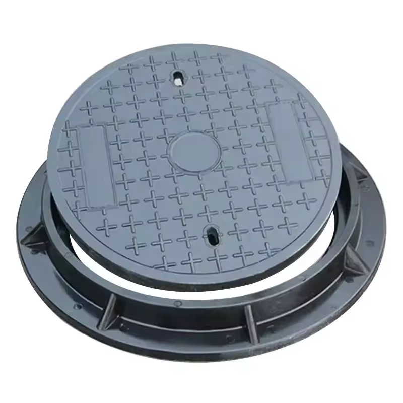 Black ductile iron round manhole cover marked BS EN124 D400 with frame